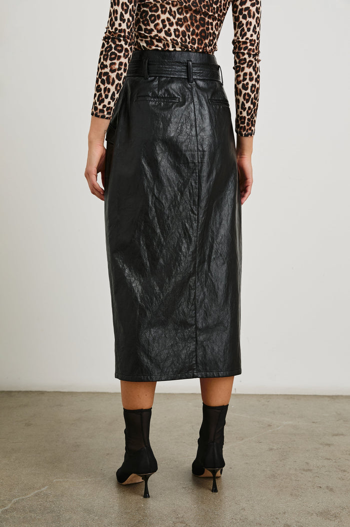 Edem Midi Skirt with a Tie Belt, a Center Slit, Four Button Closure at the Waist, Two Front Pockets Each Overlaid with a Button Flap Pocket and Two Back Welt Pockets in Black Colorway - Back View Featured on Model