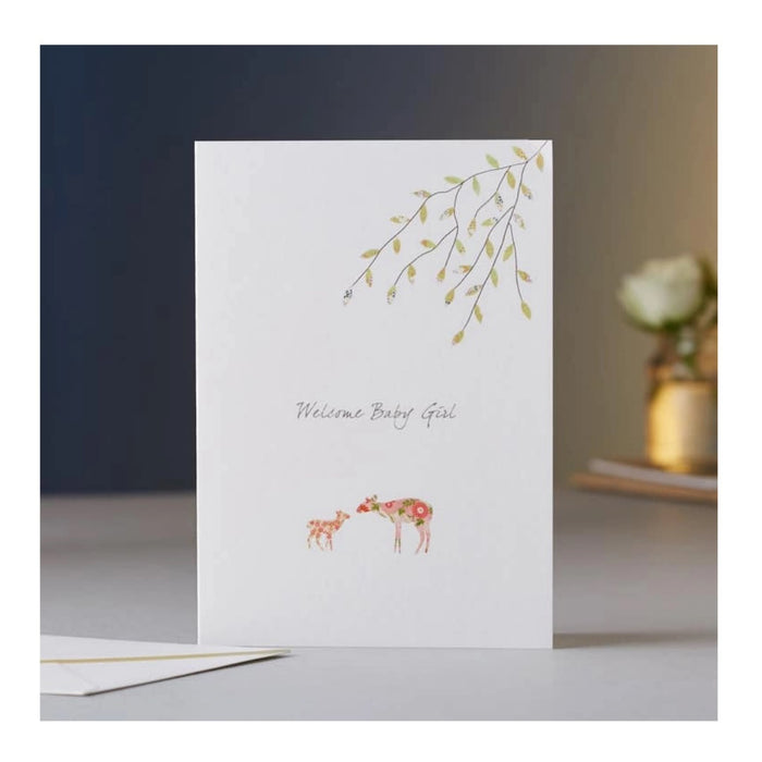 The ELOISE HALL - NEW BABY GIRL CARD by ELOISE HALL LTD features “Welcome Baby Girl” on the front with a floral deer and green leaves design—perfect for luxury stationery lovers.