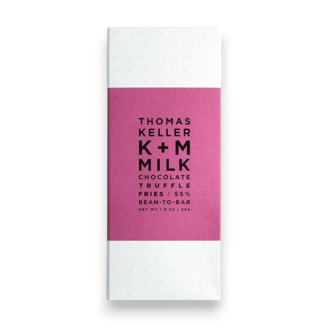 A K+M - MILK CHOCOLATE TRUFFLE FRIES BAR by K & M EXTRAVIRGIN CHOCOLATE, wrapped in white with a magenta label featuring black text, is a bean-to-bar milk chocolate crafted in Napa Valley and infused with the savory flavor of Truffle Fries for a uniquely distinctive treat.
