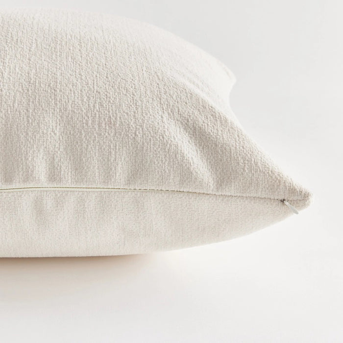 Against a plain white background, the NAPA HOME AND GARDEN - COOPER SQUARE INDOOR-OUTDOOR PILLOW 20", with its soft and fluffy Jacquard texture, appears smooth and slightly plump, ideal for resting or sleeping in any weather-resistant setting.