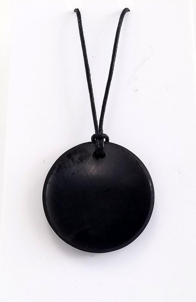A black round shungite pendant on a waxed cotton cord with a sliding knot adjustment