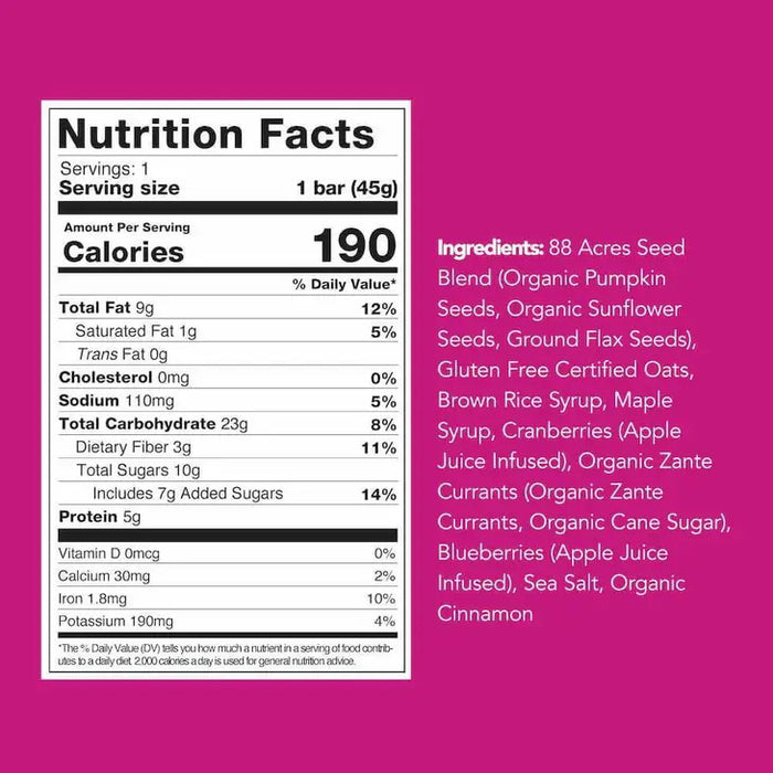 An 88 ACRES - TRIPPLE BERRY CRUMBLE bar by 88 ACRES, a nut-free vegan oat bar, rests on a light wooden surface in its white and purple berry-themed wrapper featuring nut-free, vegan, and gluten-free labels.