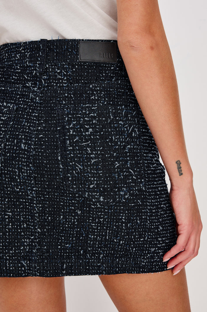 Abbot Mini Skirt in Rigid Denim With Tweed Texture With High-Rise High-Waisted Fit, Front Button Flap Pockets, and Front Zip Closure - Full Body Front View Featured on Model