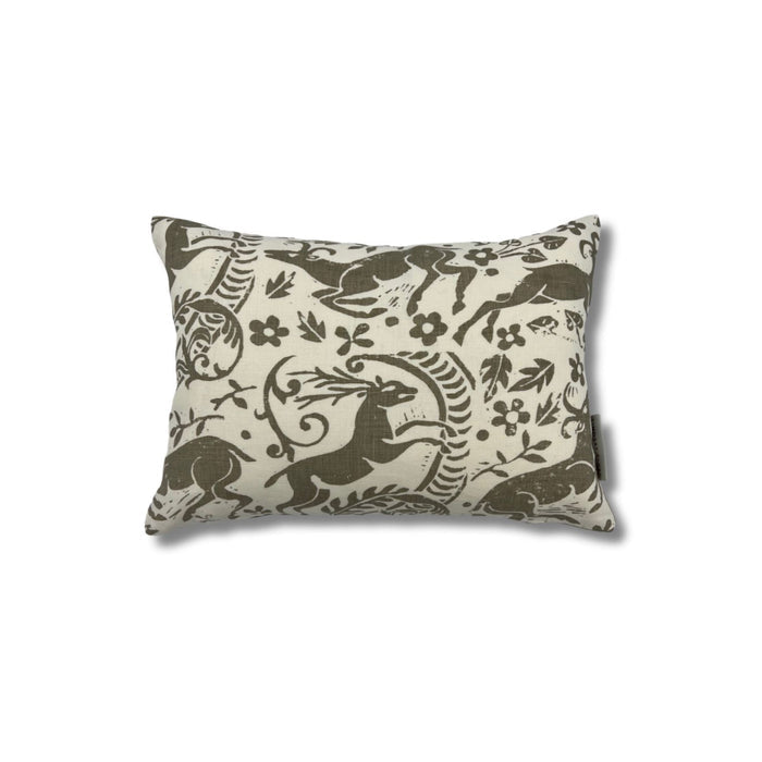 Rectangular throw pillow with a warm grey ram and botanical printed pattern on a cream linen background.