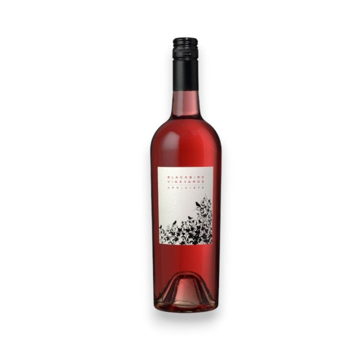 A bottle of BLACKBIRD 'ARRIVISTE' ROSÉ 2024 by WINE: ADVINTAGE, featuring a black screw cap and white label with black floral designs, is showcased against a plain white background. The label highlights Merlot from Napa Valley.