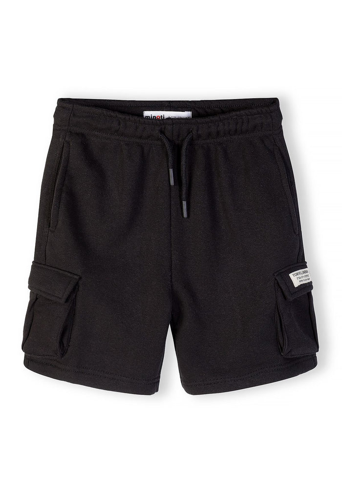 Close-up of black cargo shorts with side pockets and adjustable waistband.