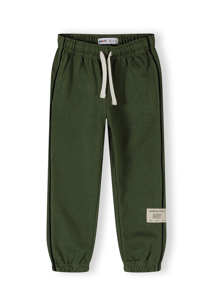 Detail of boys' khaki tracksuit trousers with elasticated waistband and side pockets.
