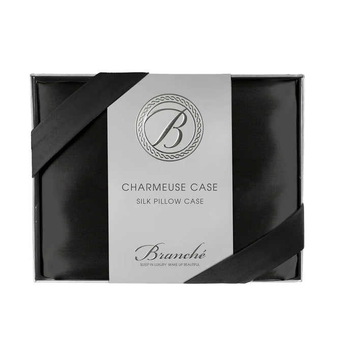 The BRANCHE - CHARMEUSE PILLOW CASE SILK is a boxed black silk pillowcase with elegant packaging, silver logo, and black ribbon accents—crafted by BRANCHE to help prevent wrinkles and reduce hair breakage.