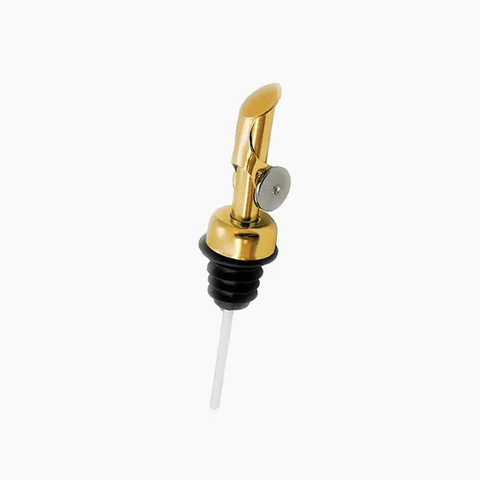 The BRIGHTLAND - SPOUT is a gold-colored pourer with a brushed gold spout, flip-top lid, black rubber stopper, and white tube. Ideal for BRIGHTLAND olive oil bottles. Isolated on a white background.