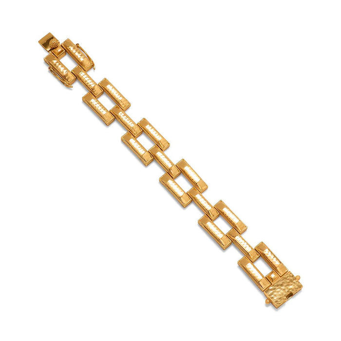 The CAPUCINE DE WULF - PATHWAY LINK BRACELET in gold features hammered, rectangular textured links in a repeating pattern, a secure clasp, and a polished finish—an elegant handmade piece by CAPUCINE DE WULF.