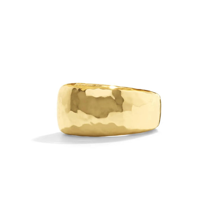 The CAPUCINE DE WULF Cleopatra Ring Size 7 features a wide gold-finished design with a slightly hammered texture. Crafted from natural materials, this elegant, reflective ring is displayed on a plain white background, embodying the brand's commitment to sophisticated handmade jewelry.
