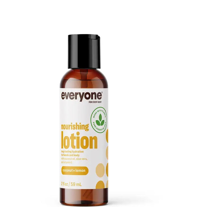 A small 2 fl oz (59 mL) brown bottle of EVERYONE FOR EVERYBODY COCONUT & LEMON TRAVEL SIZE LOTION features a black cap and a white-and-yellow label. This moisturizing lotion contains aloe vera and vitamin E for nourishing care.