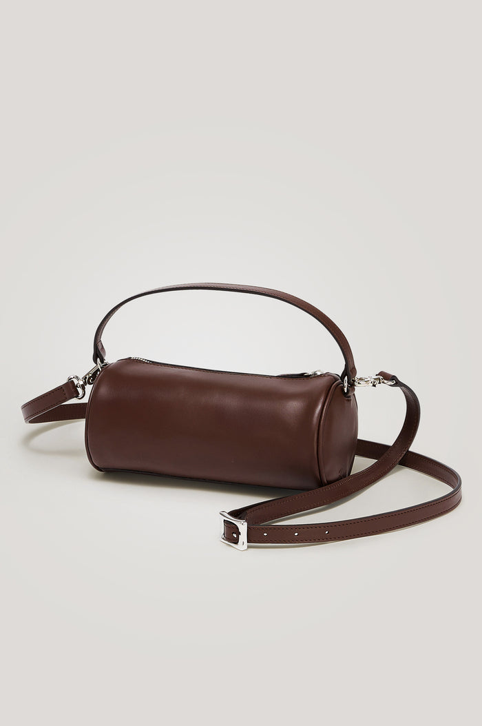 Como Mini Barrel Bag in Italian Leather With Fixed Top Strap, Removable and Adjustable Buckled Crossbody Strap, Top Zipper, Side-Embossed Logo, Branded Interior Label in Espresso Colorway - Side View Featured