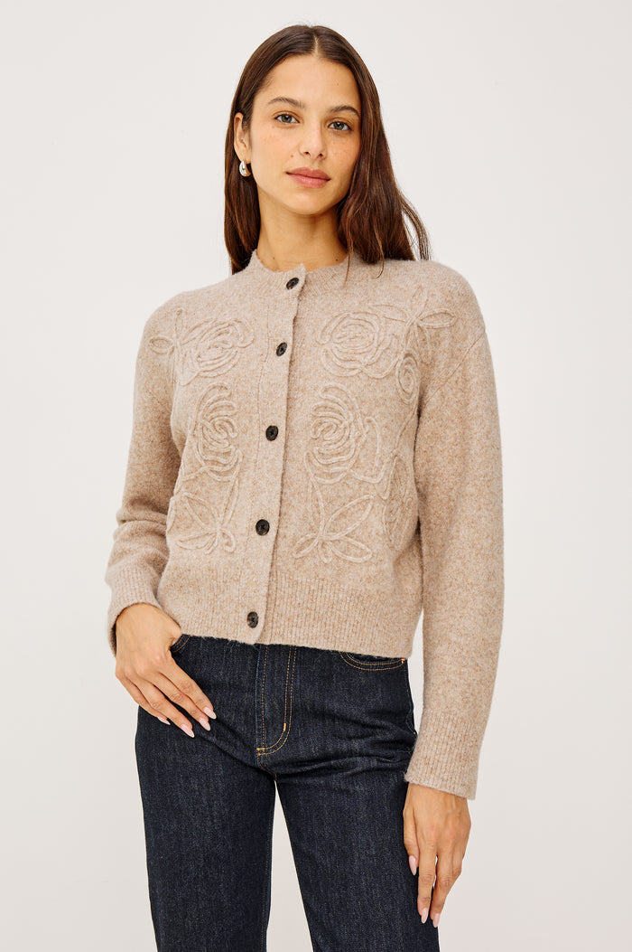 Coralee Cardigan in Alpaca Knit With Soutache Rosette Front Detailing, a Crew Neckline, Front Buttons, Ribbed Trim, and Long Sleeves in Sand Colorway - Upper Body Front View Featured on Model