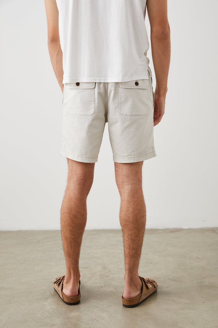 Cruz Shorts with a Drawstring Waist, Two Front Pockets, Two Back Button Flap Pockets in Natural Colorway - Back View Featured on Model