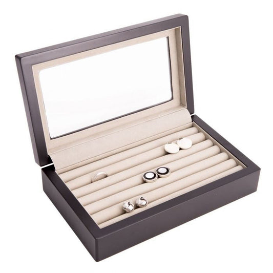 The BEYBERK INTERNATIONAL CUFFLINK BOX IN MATTE BLACK WOOD WITH GLASS TOP has a transparent lid revealing a light, cushioned interior with multiple watch slots.