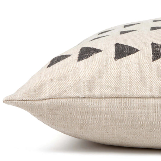 Close-up side view of THE FOGGY DOG's DOG BED (M, AMANI SAND) in beige fabric with black hand-painted triangles. Its boho style and textured weave are highlighted as it rests on a white surface, showing off its soft structure.