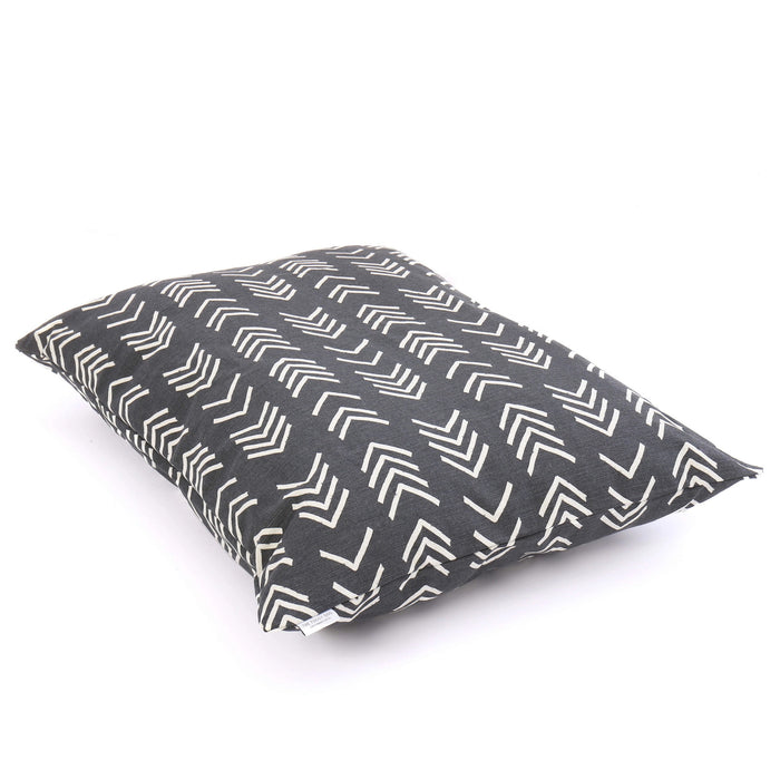 A close-up of THE FOGGY DOG BED (S, MODERN MUD CLOTH BLACK) shows its dark gray fabric with white chevron pattern, pointed corner, and stitched seam against a plain background—a stylish accent for any boho dog bed setup.