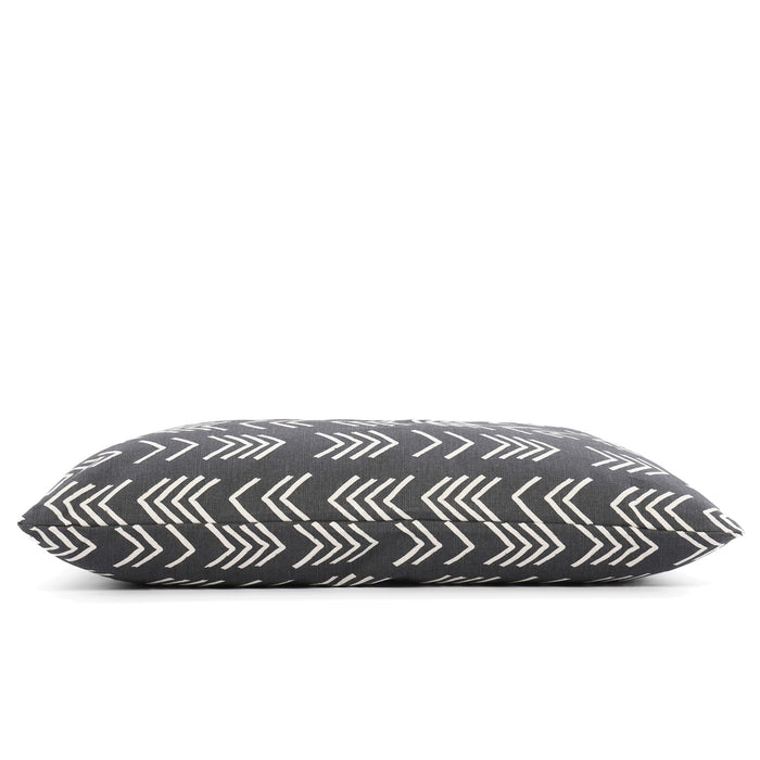 A close-up of THE FOGGY DOG BED (S, MODERN MUD CLOTH BLACK) shows its dark gray fabric with white chevron pattern, pointed corner, and stitched seam against a plain background—a stylish accent for any boho dog bed setup.