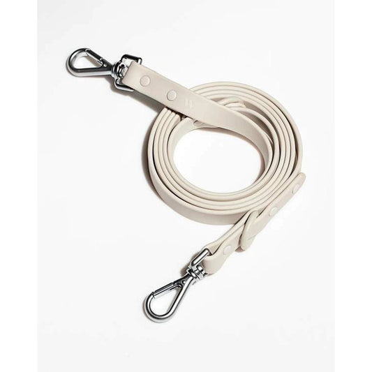 The WILD ONE DOG LEASH (S, GREY) features dirt- and odor-resistant flex-poly straps, silver metal clips at both ends, and is shown coiled on a white background.