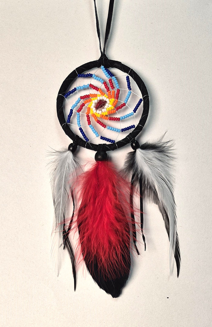 2.5" diameter black beaded Dream Catcher detailed with beads, a semi-precious gemstone and feathers as shown. Handmade in Canada.