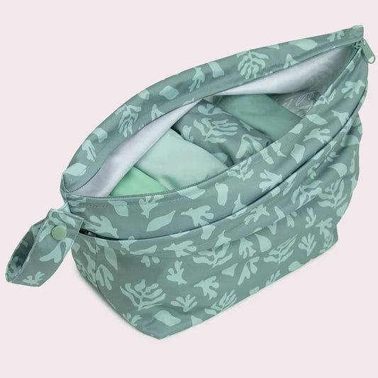 Green patterned bag on a light pink background