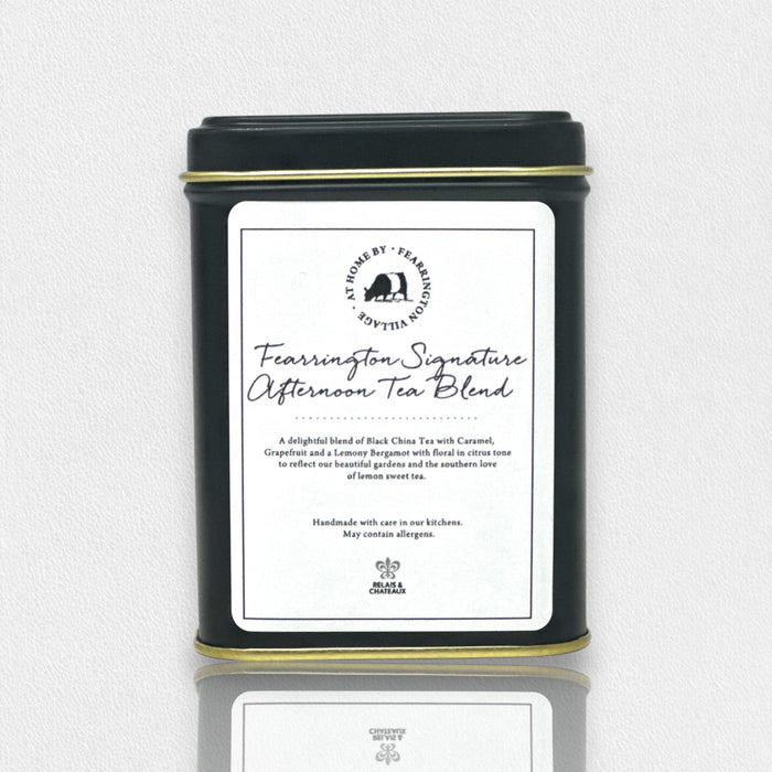 A black tin labeled “Fearrington Signature Afternoon Tea Blend” contains a loose leaf mix of black Ceylon teas with caramel, grapefruit, and lemon. Part of the Fearrington Signature Collection by Fearrington House.