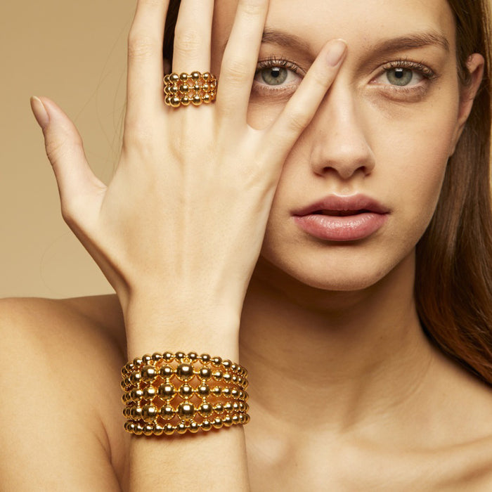 The GAS BIJOUX - MUTIPERLA RING features three rows of polished, gold-plated beads in an adjustable, open-back design by GAS BIJOUX, displayed against a white background.