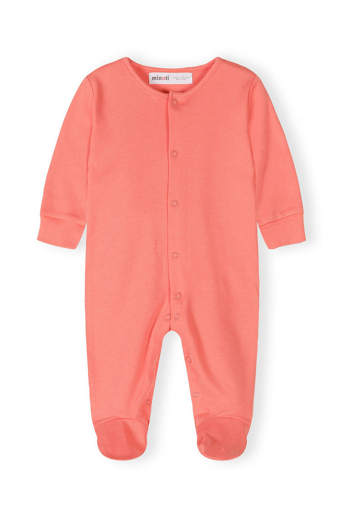 Close-up of a coral long-sleeve sleepsuit with press studs and elasticated cuffs.