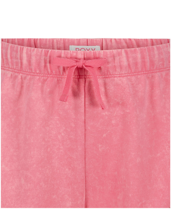 Close-up of Girls' Sunset Short by Roxy in pink French terry, featuring an elastic waistband with matching pink drawstring and a visible back label.
