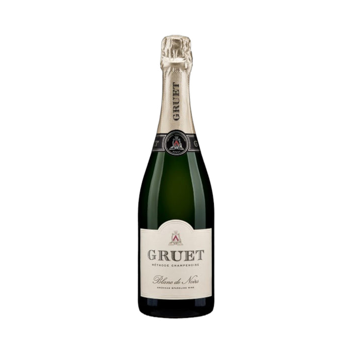 A bottle of Gruet Blanc de Noirs sparkling wine from New Mexico, crafted using the Champagne method, has a green glass body, beige foil on the neck, and a white label with black text for Wine: Empire Distributing.