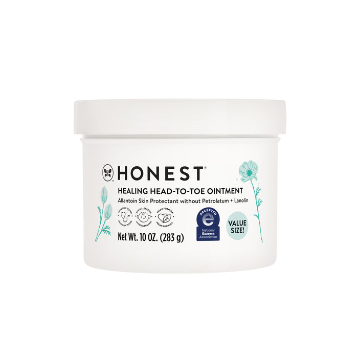 A white container of The Honest Companys Healing Head to Toe Ointment features allantoin for healthy skin, minimalist floral graphics, petrolatum and lanolin-free text, and is available in a generous 10 oz. value size.