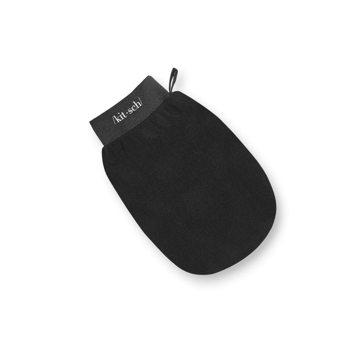 The KITSCH - KIRACH black exfoliating glove offers gentle skincare exfoliation with its smooth texture, elastic cuff, and hanging loop. Ideal for promoting skin cell renewal, it features the brand name printed on it.