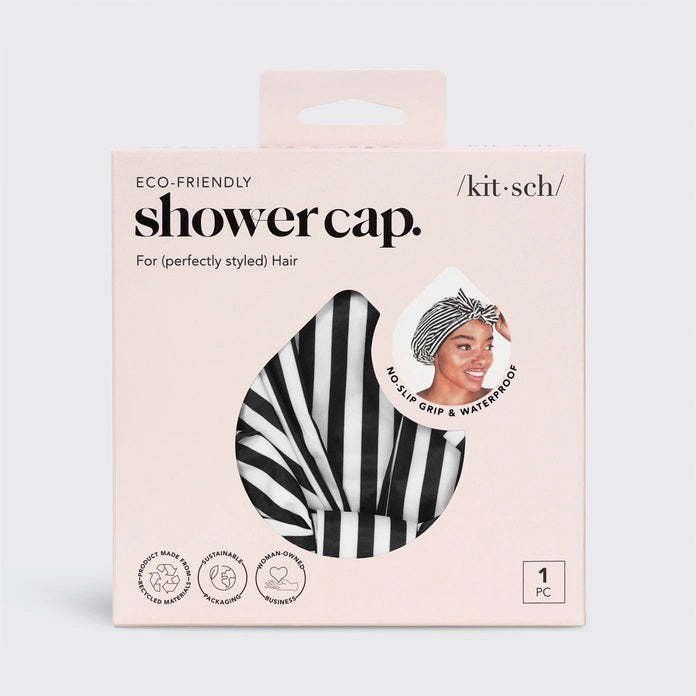 The KITSCH - LUXURY SHOWER CAP, with chic black and white stripes, is elegantly showcased in a pink box. The packaging highlights its waterproof, no-slip grip features and charming illustrations, complemented by a model's photo demonstrating its beauty.