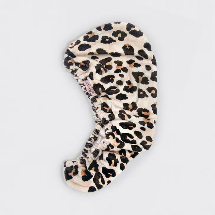 The KITSCH Quick Dry Hair Towel packaging highlights its luxurious eco-friendly blend of organic cotton and bamboo, showcasing softness and high absorbency. An image emphasizes friction-free drying, with the towel elegantly displayed beside the box, reflecting its natural allure.