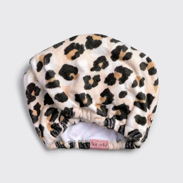 The KITSCH Quick Dry Hair Towel packaging highlights its luxurious eco-friendly blend of organic cotton and bamboo, showcasing softness and high absorbency. An image emphasizes friction-free drying, with the towel elegantly displayed beside the box, reflecting its natural allure.