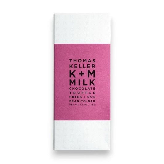A K+M - MILK CHOCOLATE TRUFFLE FRIES BAR by K & M EXTRAVIRGIN CHOCOLATE, wrapped in white with a magenta label featuring black text, is a bean-to-bar milk chocolate crafted in Napa Valley and infused with the savory flavor of Truffle Fries for a uniquely distinctive treat.