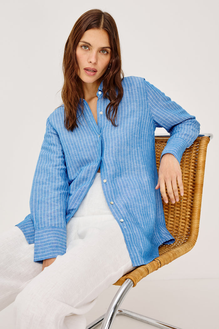 Knox Button-Up Shirt in Linen Viscose With Collar, Front Buttons, Long Sleeves, and Relaxed Fit in Avalon Stripe Colorway - Upper Body Front View Featured on Model Sitting