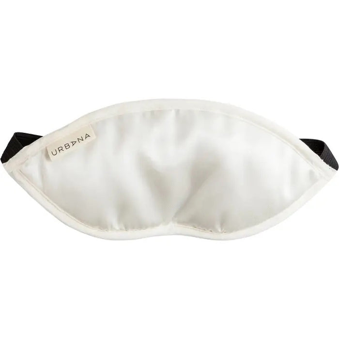 A white satin sleep mask with a black elastic strap and "URBANA" tag pairs perfectly with the LAVENDER SILK EYE PILLOW by EUROPEAN SOAPS, LLC for ultimate relaxation.