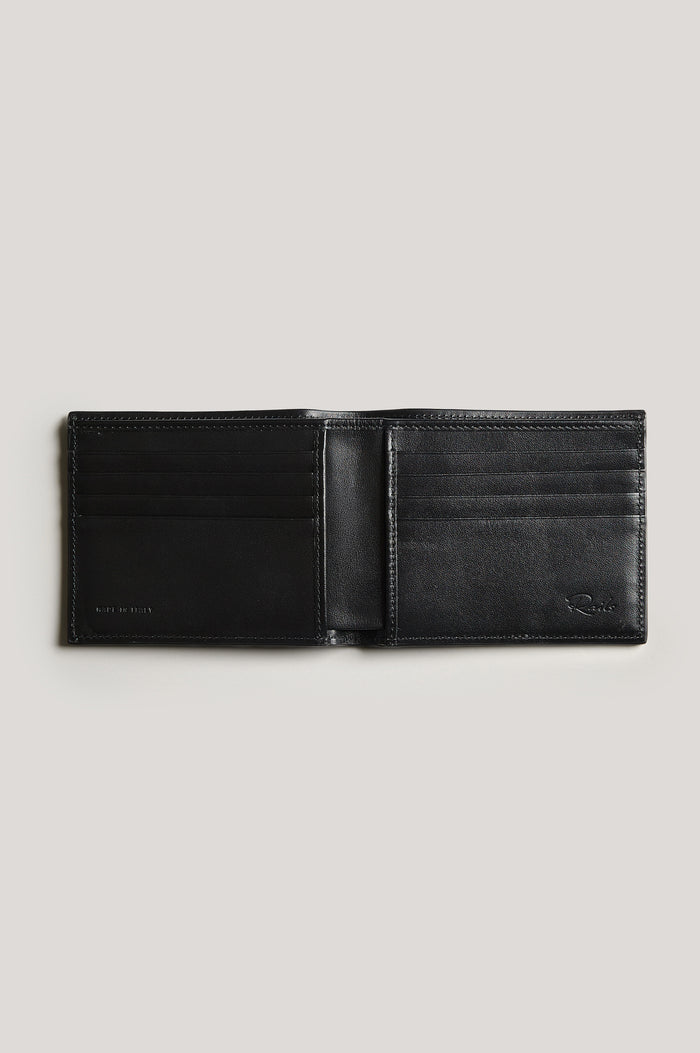 Leather wallet in black color, split open. Inside view featured.