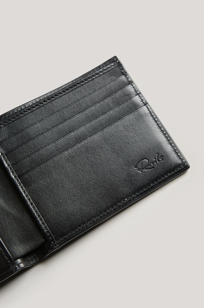 Leather wallet in black color, split open. Close up of inside view featured.