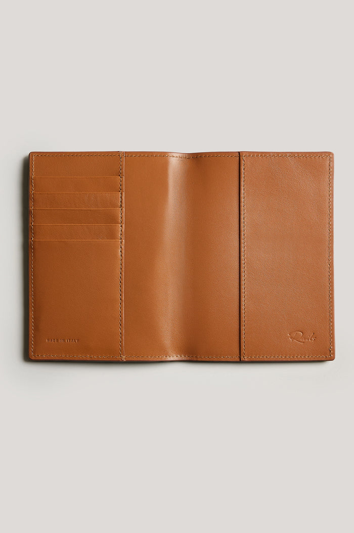 Leather passport holder opened, detailed inside view with, in brown Cognac colorway.