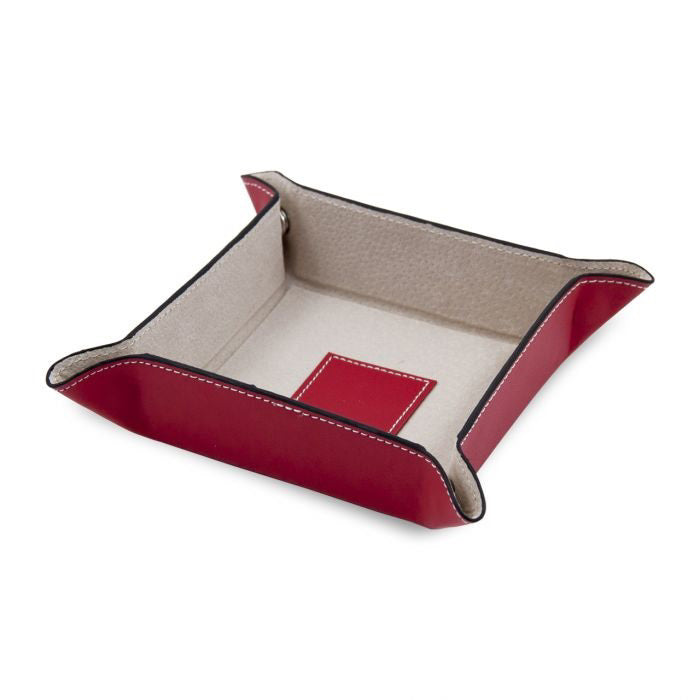 The BEYBERK INTERNATIONAL LEATHER VALET IN RED is a square leather tray with a red exterior, beige pigskin leather lining, raised sides, white stitching, and a small red patch on the interior bottom.