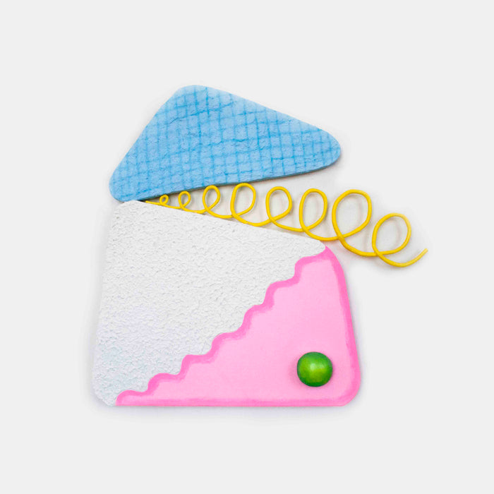 The artwork 'Loopy Cocktail Burp' by Ryan Patrick Martin features a geometric composition with a light blue triangular shape, a white textured block, and a pink scalloped corner accent. A vibrant yellow spiral wire emerges from the center, while a small green spherical element adds a playful touch. Mixed media construction combines wood, canvas, and epoxy clay with acrylic paint by Ryan Patrick Martin.