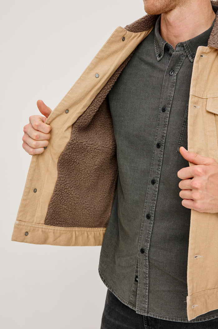 McKinley Jacket with Button Closure, Two Chest Button Flap Pockets and a Brown Contrast Collar in Duck Colorway. Front Detail View Featured on Model.