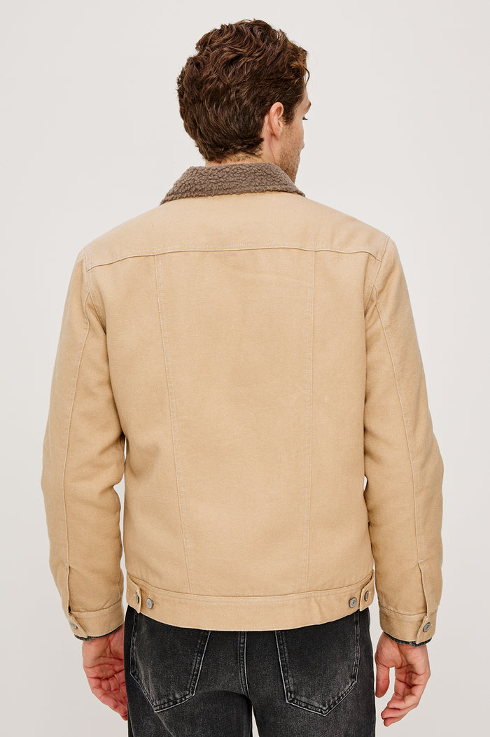 McKinley Jacket with Button Closure, Two Chest Button Flap Pockets and a Brown Contrast Collar in Duck Colorway. Back View Featured on Model.
