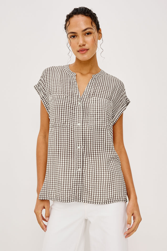 Mel Boxy Button-Up Shirt With Ruffled Cap Sleeves Banded V-Neckline Front Buttons Chest Patch Pockets and Curved High Neckline in Espresso Gingham - Full Body Front View Featured on Model