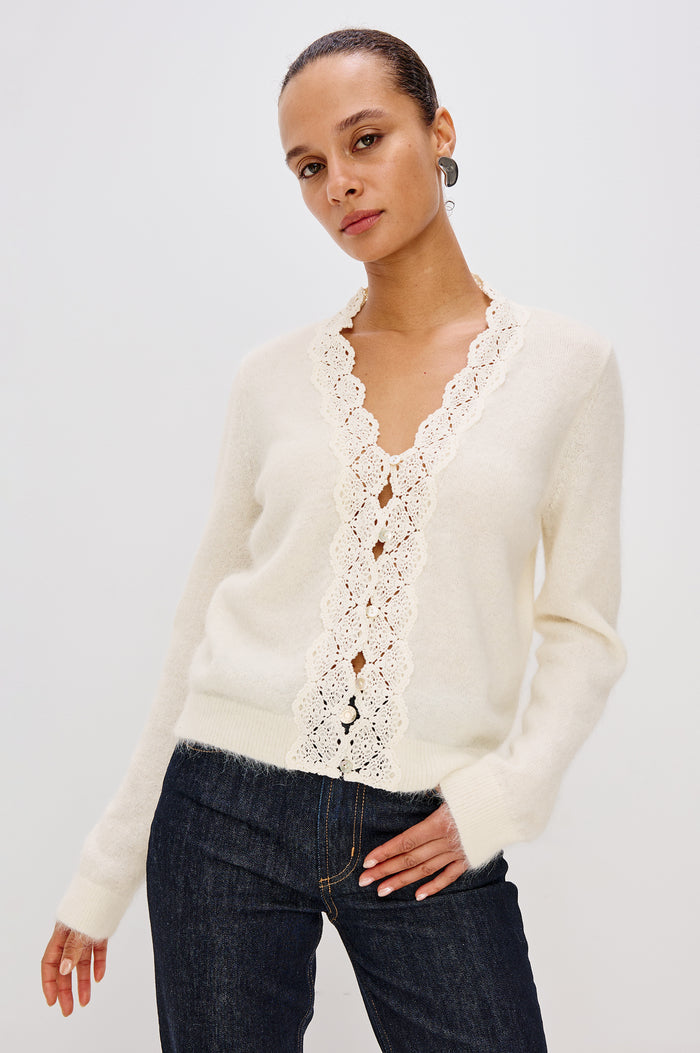 Mer Relaxed Fit Knit Cardigan in Soft Alpaca-Wool Brand With a V-Neckline, Lace Trim, Front Button Closures, and Long Sleeves in Ivory Colorway - Upper Body Front View Featured on Model