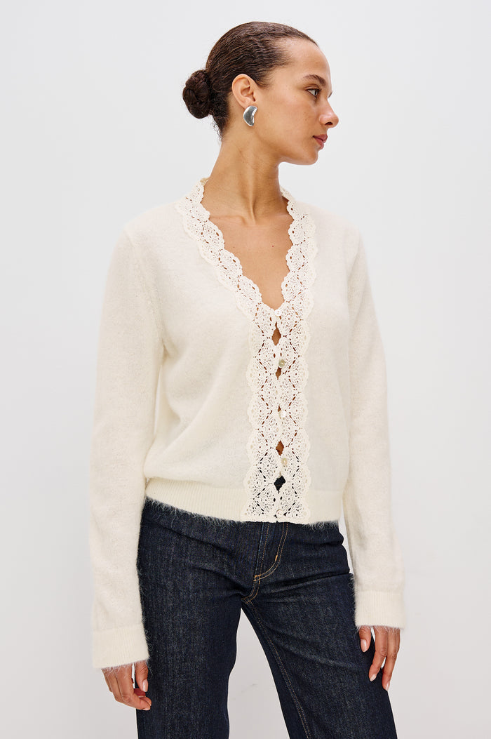 Mer Relaxed Fit Knit Cardigan in Soft Alpaca-Wool Brand With a V-Neckline, Lace Trim, Front Button Closures, and Long Sleeves in Ivory Colorway - Upper Body Front View Featured on Model