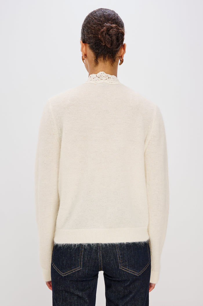 Mer Relaxed Fit Knit Cardigan in Soft Alpaca-Wool Brand With a V-Neckline, Lace Trim, Front Button Closures, and Long Sleeves in Ivory Colorway - Upper Body Back View Featured on Model